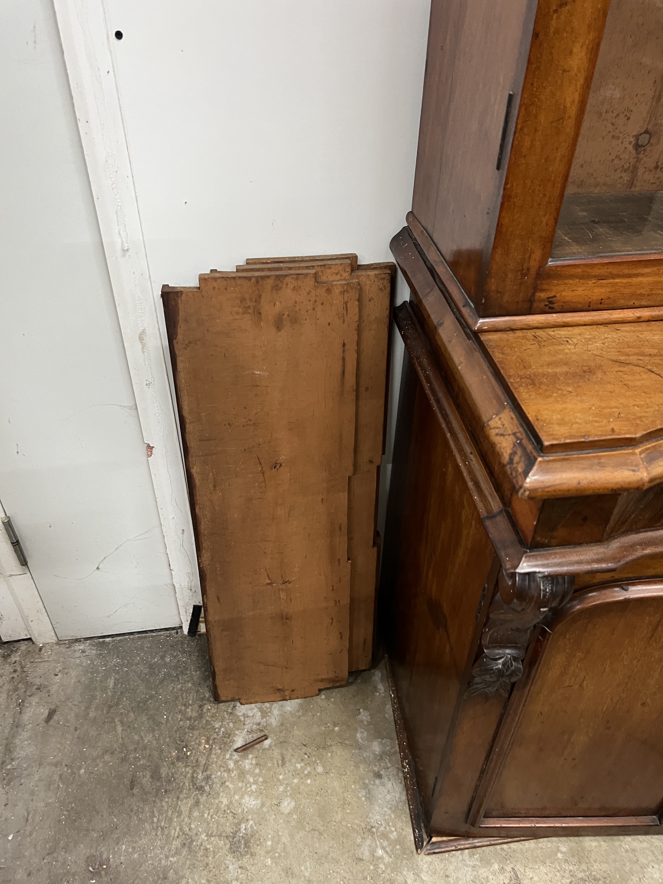 A Victorian serpentine mahogany bookcase cupboard, width 88cm, depth 48cm, height 205cm